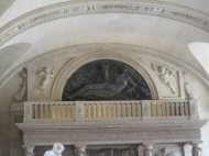 balcony above column statues